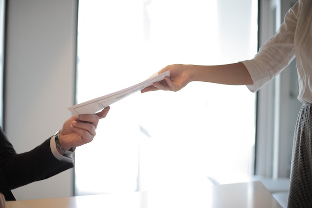 hands exchanging lease agreement